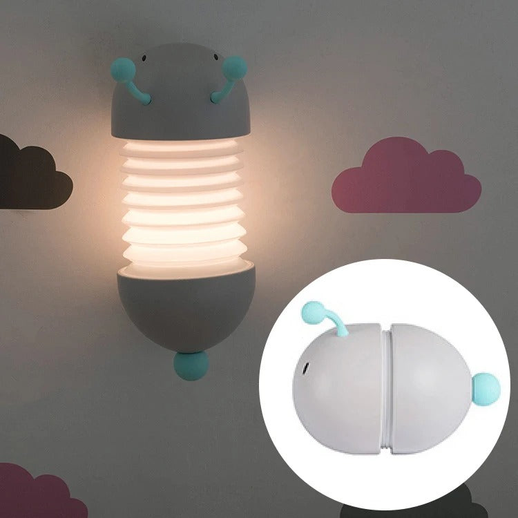 Magnetic Suction Caterpillar LED Night Light, grey with teal antennae, lit vertically on a wall, folded inset