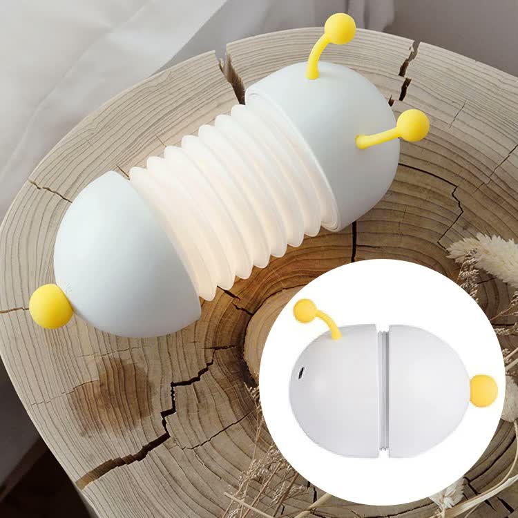 Magnetic Suction Caterpillar LED Night Light, lit white accordion body with yellow antennae, on wood, folded inset
